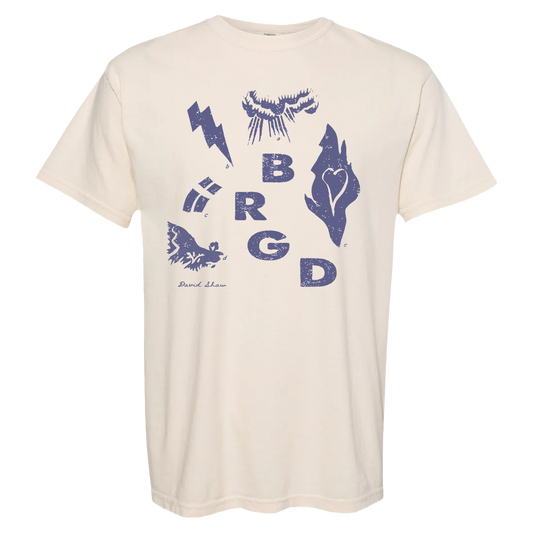 Cream-colored t-shirt with blue graphic designs including letters ’BRGD’ and various symbols.