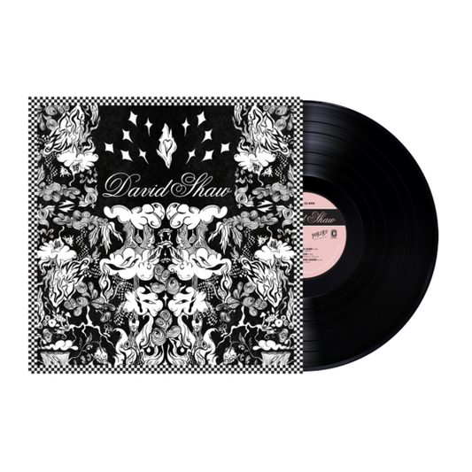 Vinyl record album with an ornate black and white floral design on its cover.