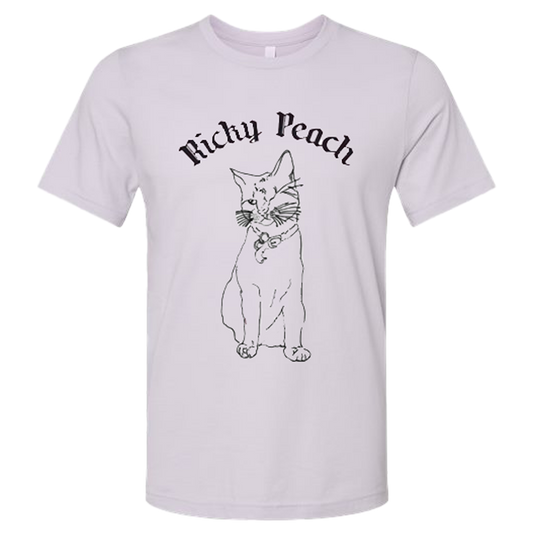 Light-colored t-shirt featuring a black line drawing of a cat and the text ’Richy Peach’ above it.